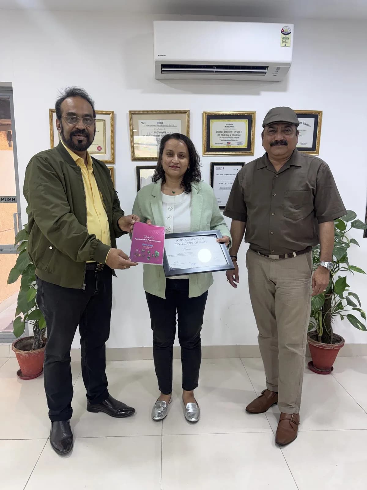 A graduate receiving her Qualified Gemstone Professional (QGP) certificate
