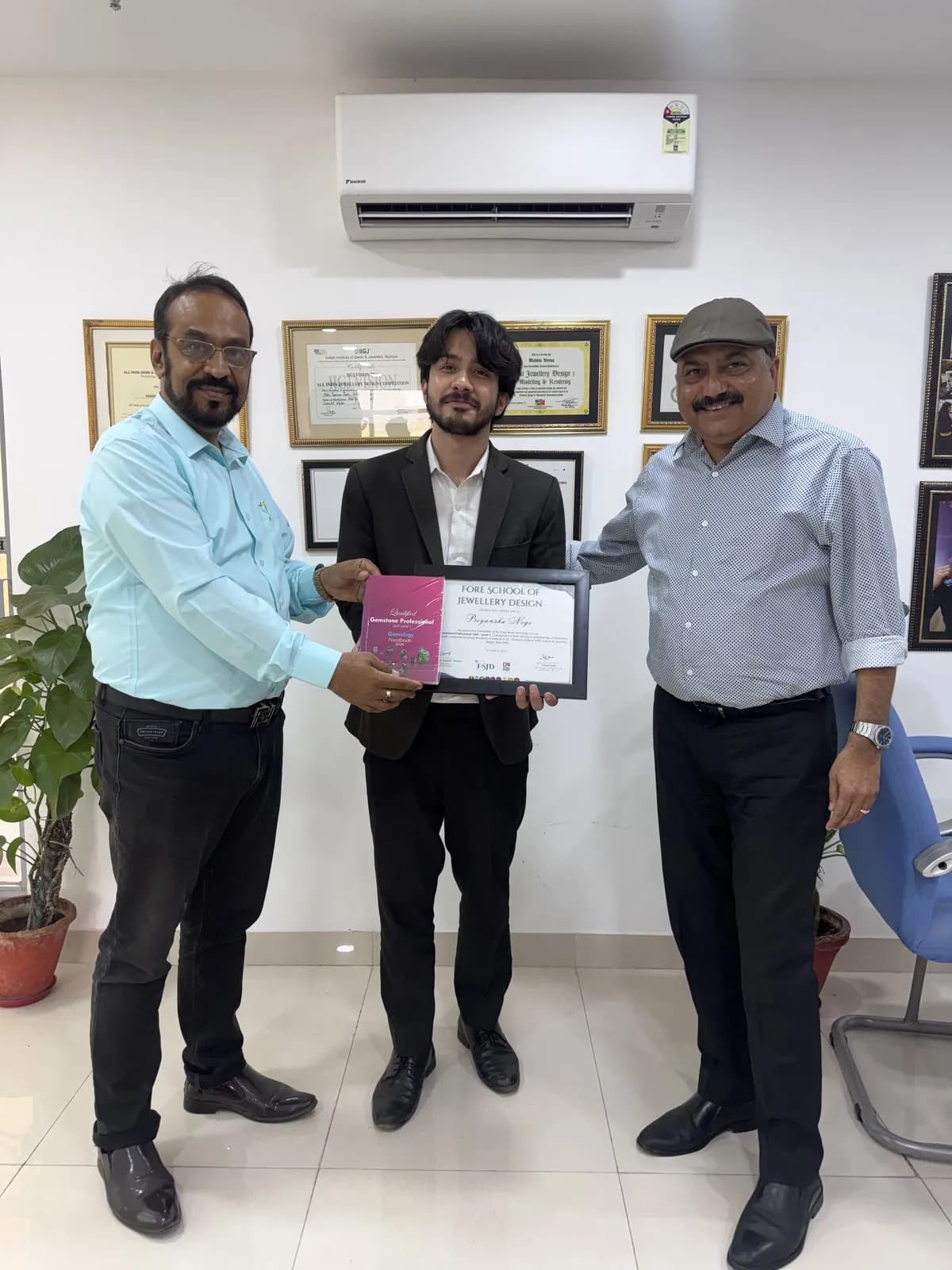 A student receiving his Qualified Gemstone Professional (QGP) certificate
